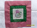 Dragon cross stitch square bordered in green and backed by rose pink polycotton. Won by Shezz YDC 67